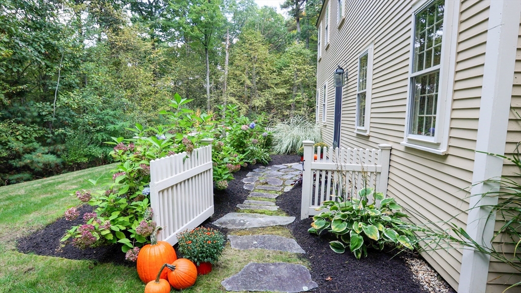 a view of a backyard with garden and patio