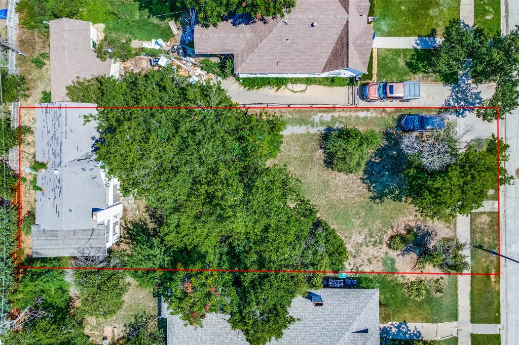 an aerial view of a house with a yard and garden