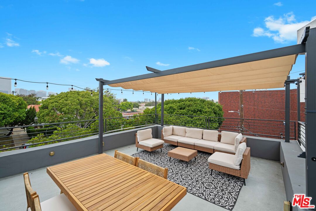 a balcony with furniture and a table