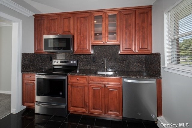 a kitchen with stainless steel appliances granite countertop a stove microwave and sink