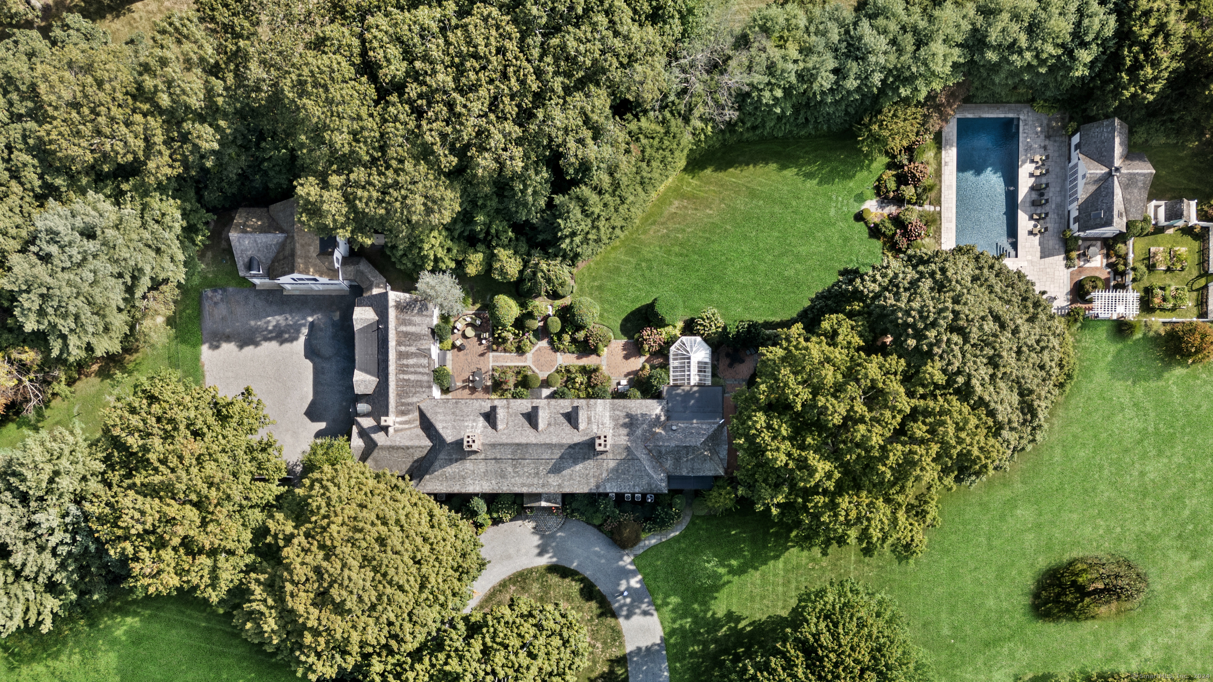 Timeless elegance meets modern comfort in this stately Colonial, set on beautifully manicured grounds with a classic circular driveway