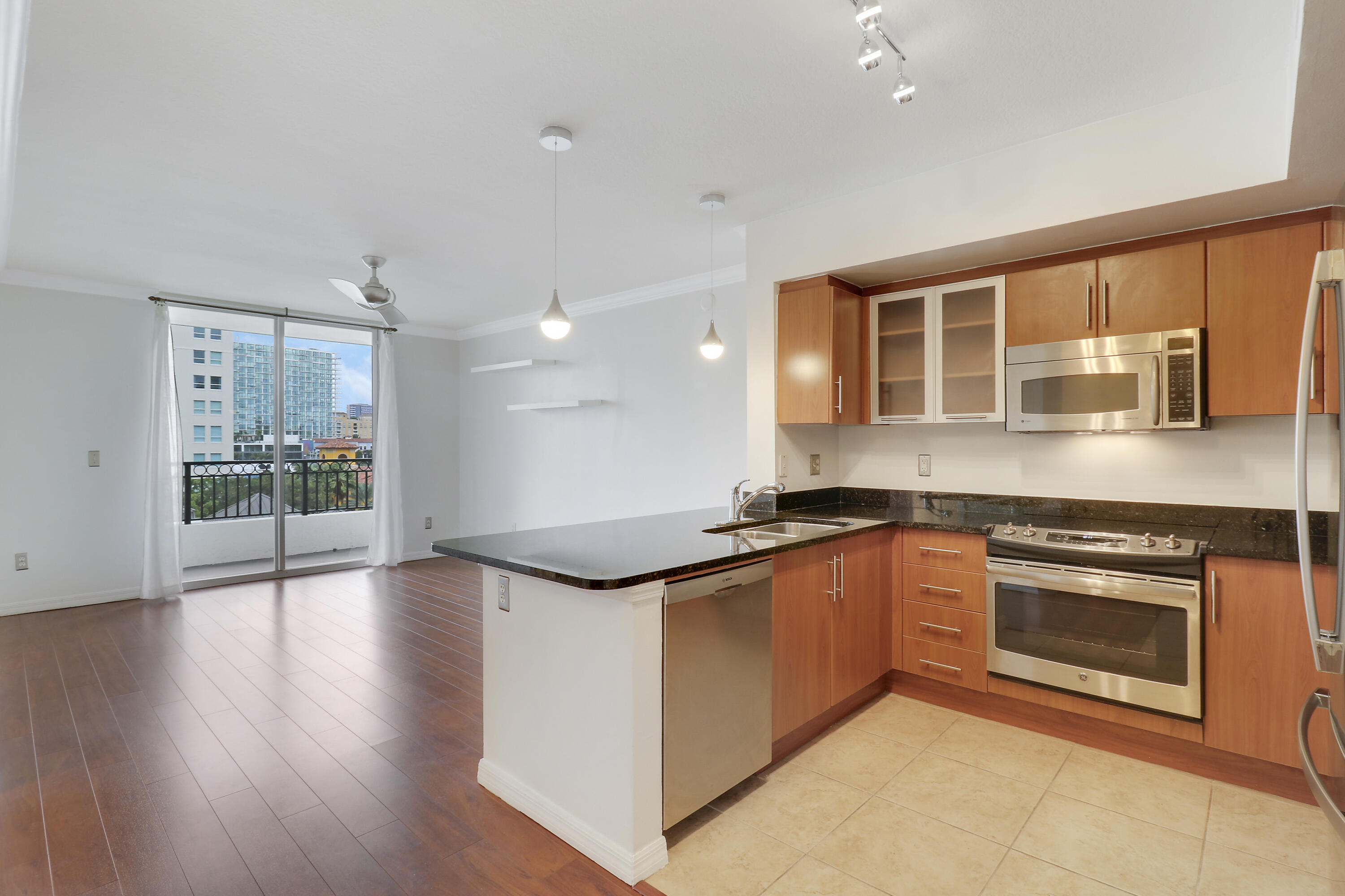 a kitchen with granite countertop a stove top oven and sink