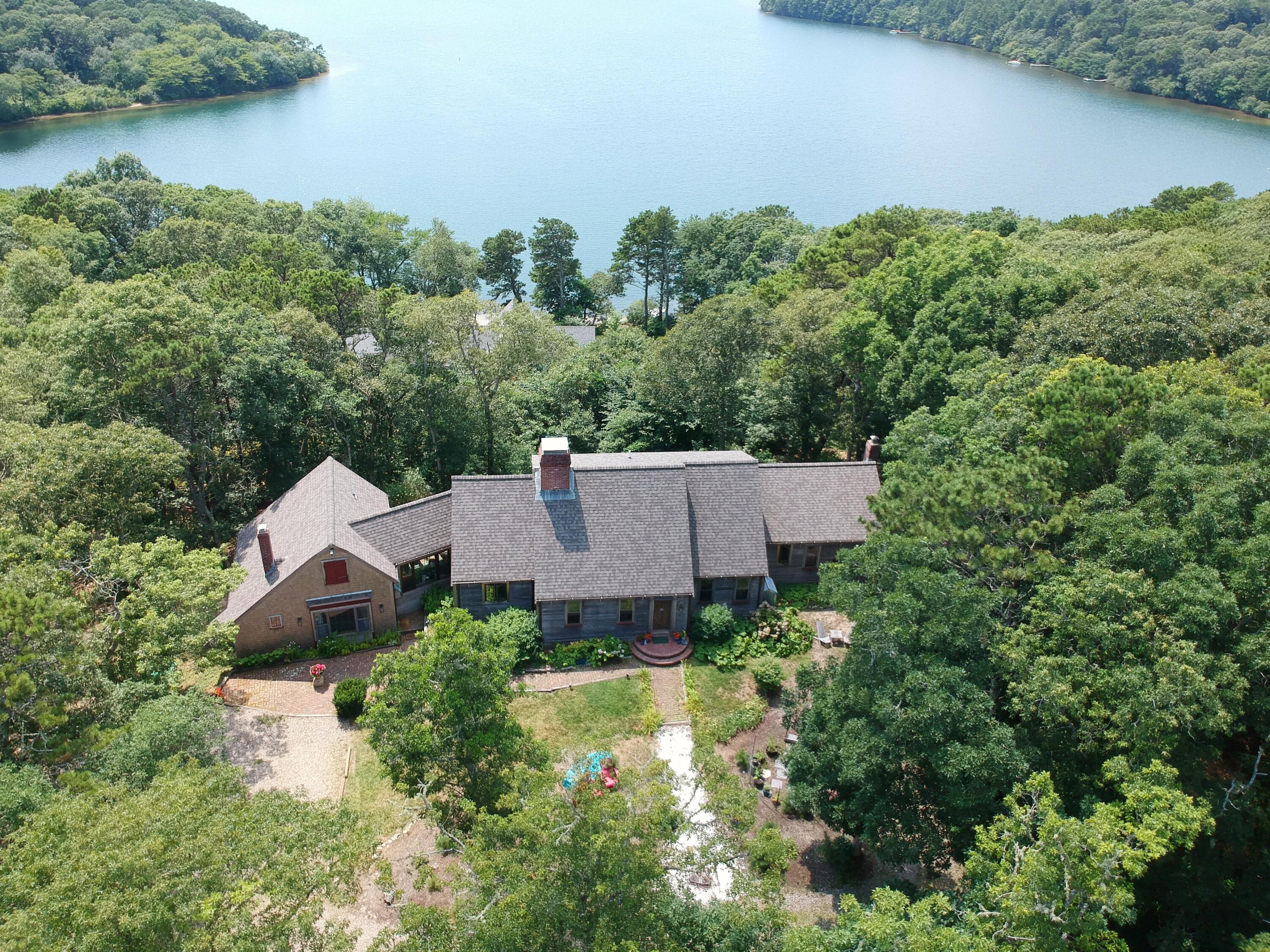 an aerial view of a house with a garden and a yard