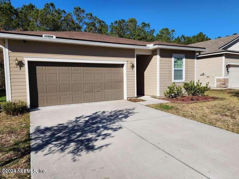 a front view of a house with a yard and garage