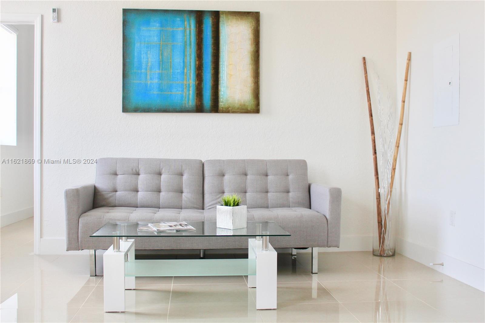 a living room with furniture and a potted plant