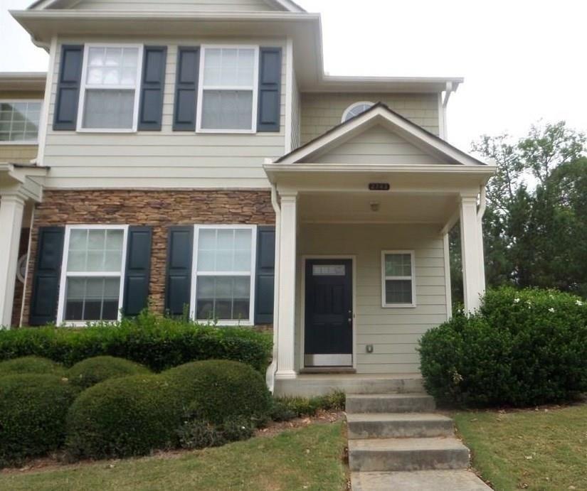 a front view of a house with a yard