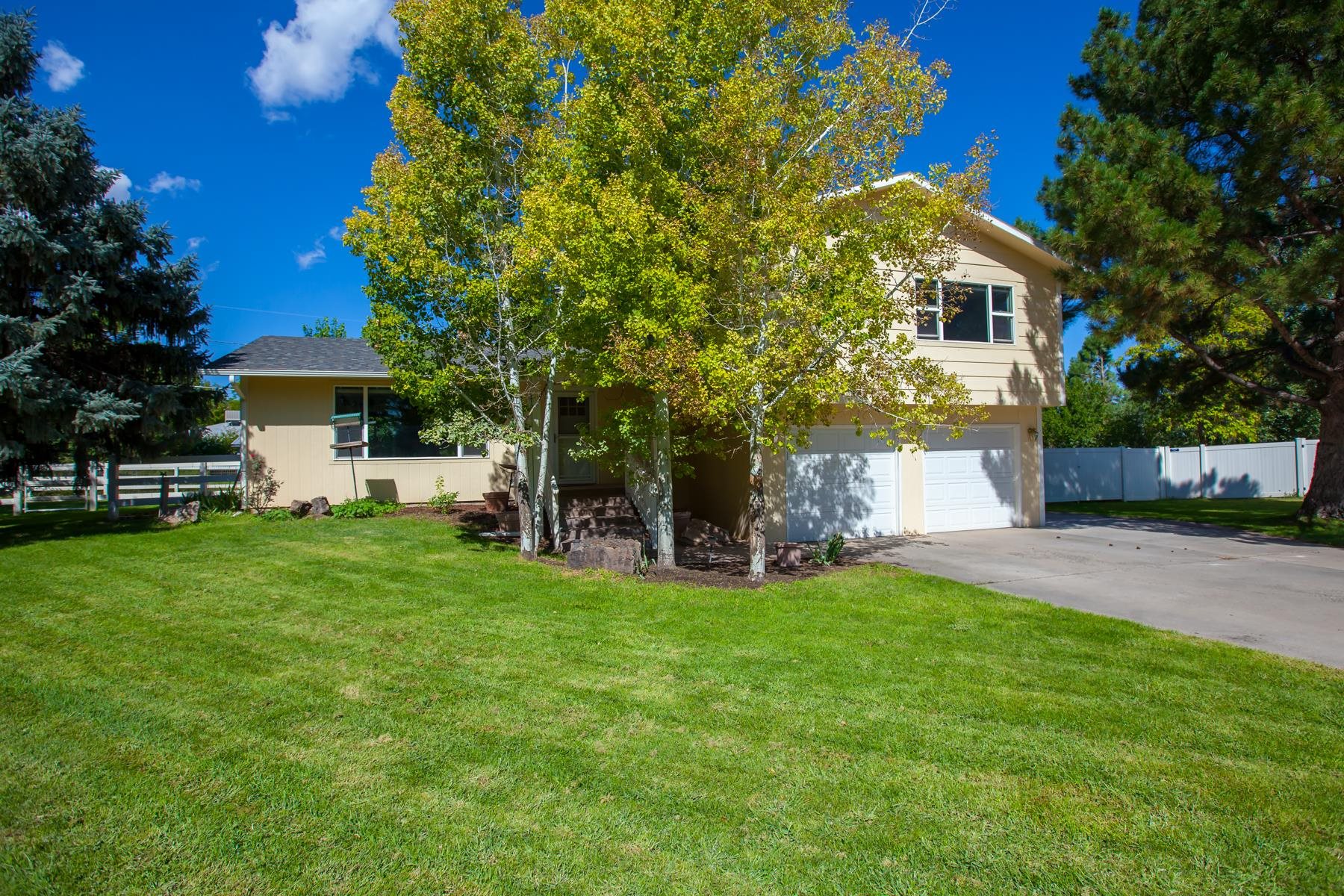 a view of a house with a yard and sitting area