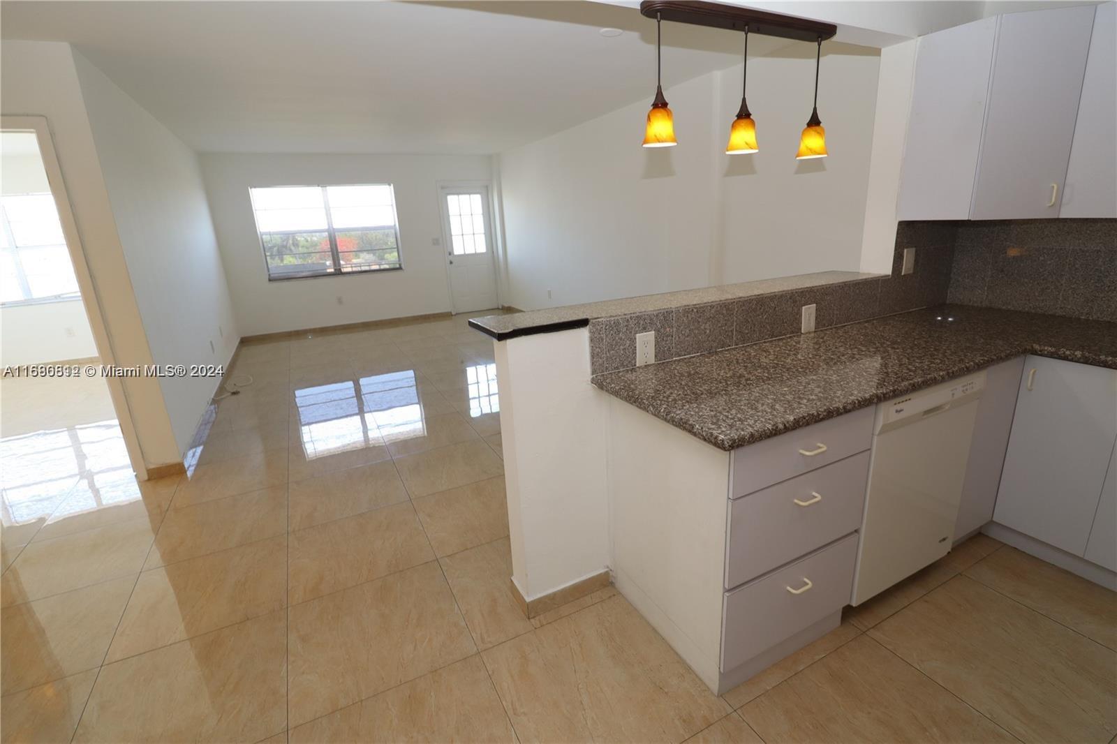 a kitchen with stainless steel appliances granite countertop a sink and a granite counter tops