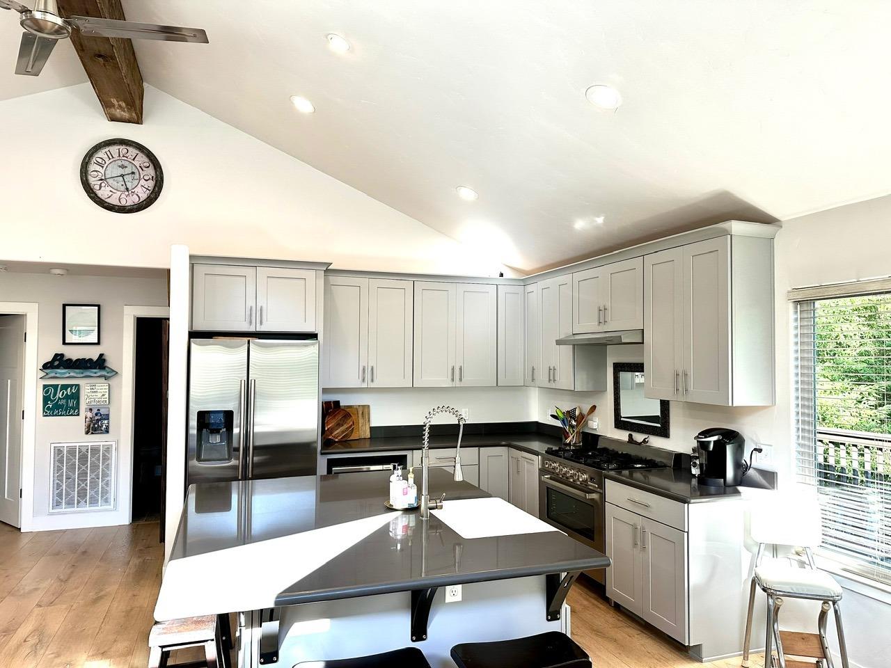 Beautiful new kitchen with stainless steel appliances and a farmhouse sink in the island.