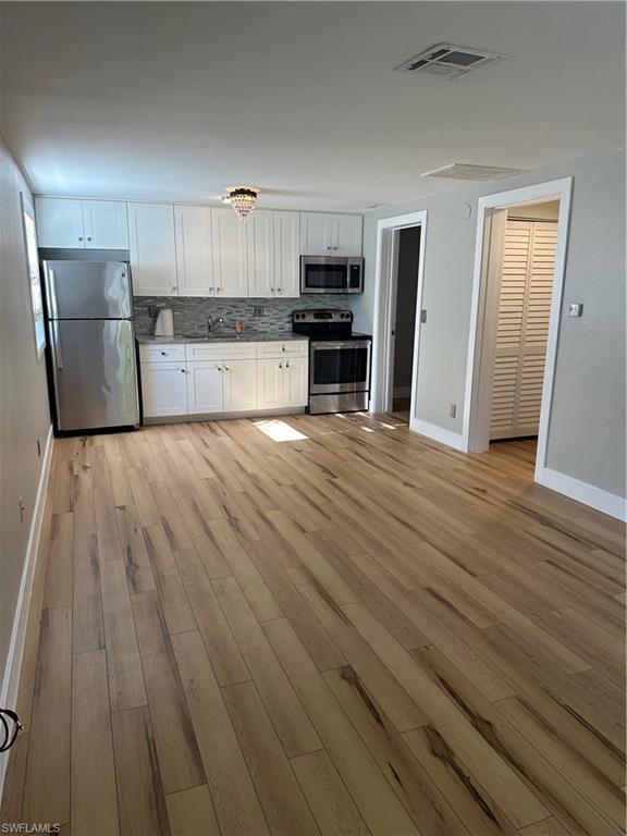 a view of kitchen with wooden floor