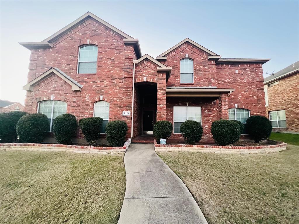 a front view of a house with yard