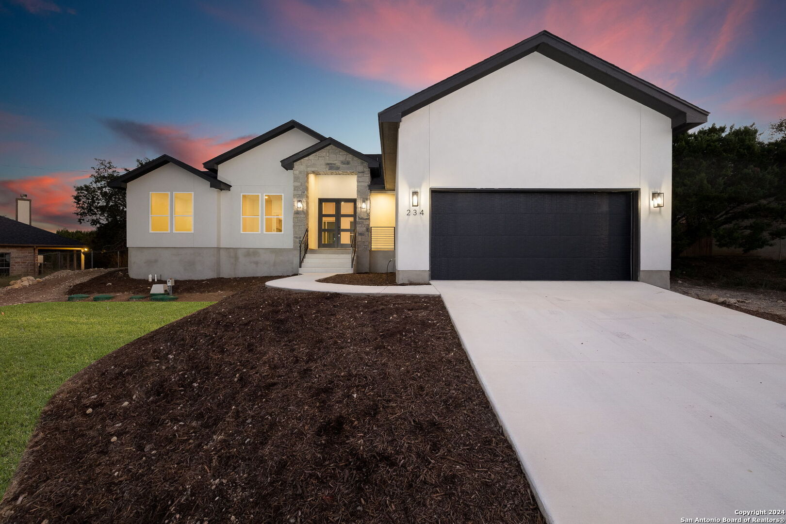 a front view of a house with a yard and garage