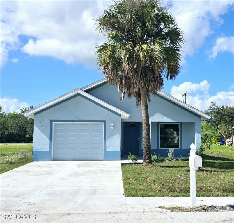 a house with a yard and a palm tree