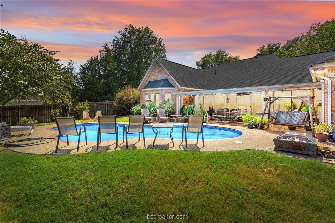 a view of a house with swimming pool and a big yard