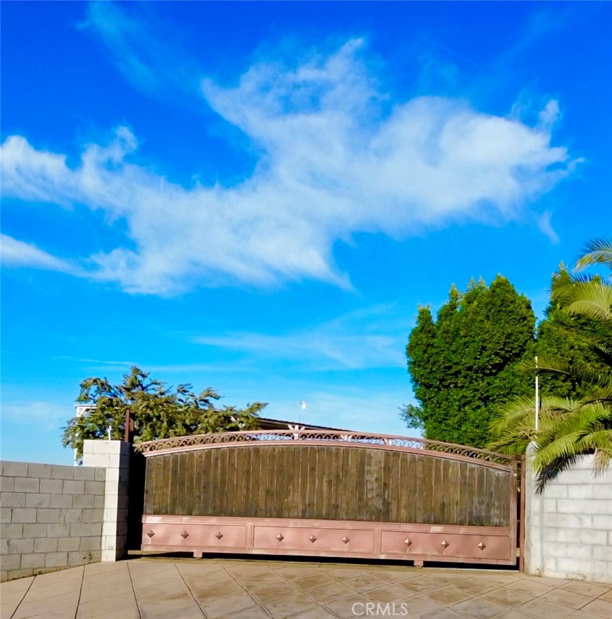 a view of a yard with wooden fence