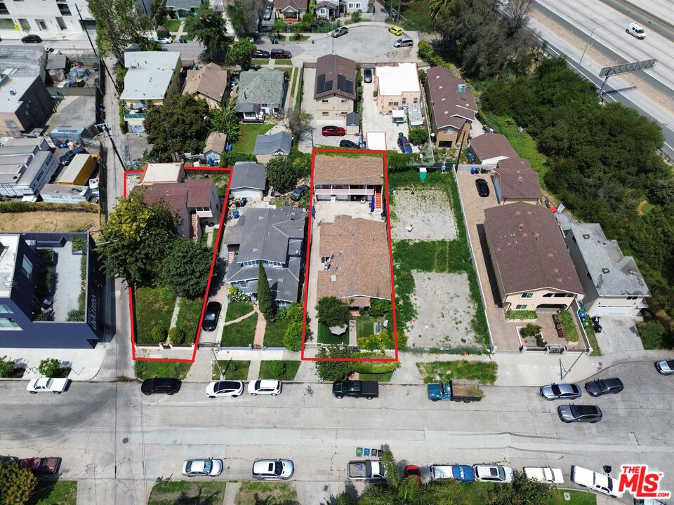 an aerial view of multiple houses with yard