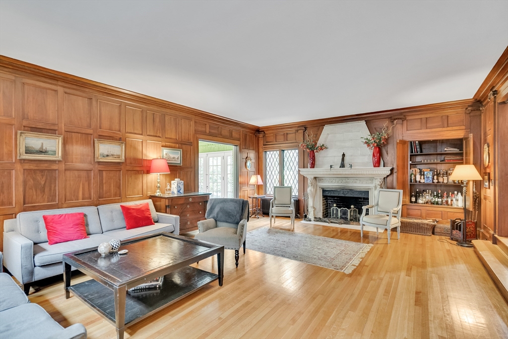 a living room with furniture fireplace and a table