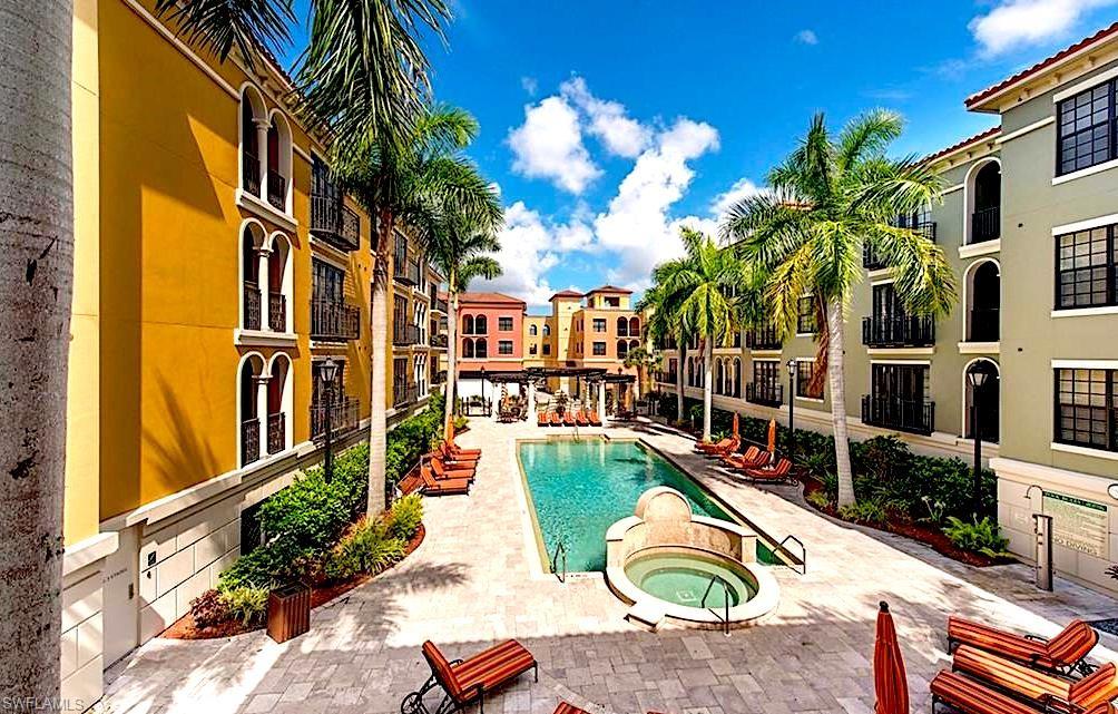 View of swimming pool with a hot tub and a patio area