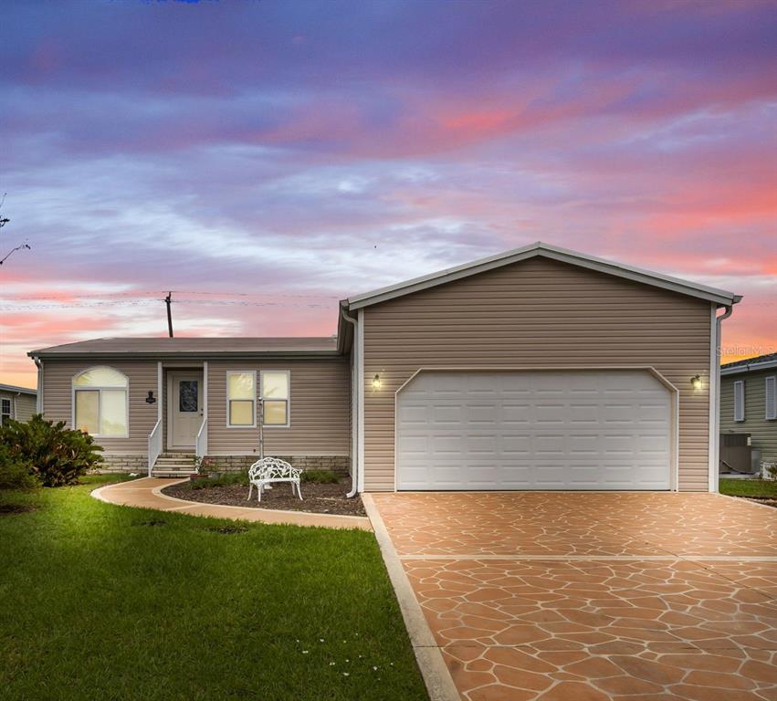 a front view of house with yard and outdoor seating