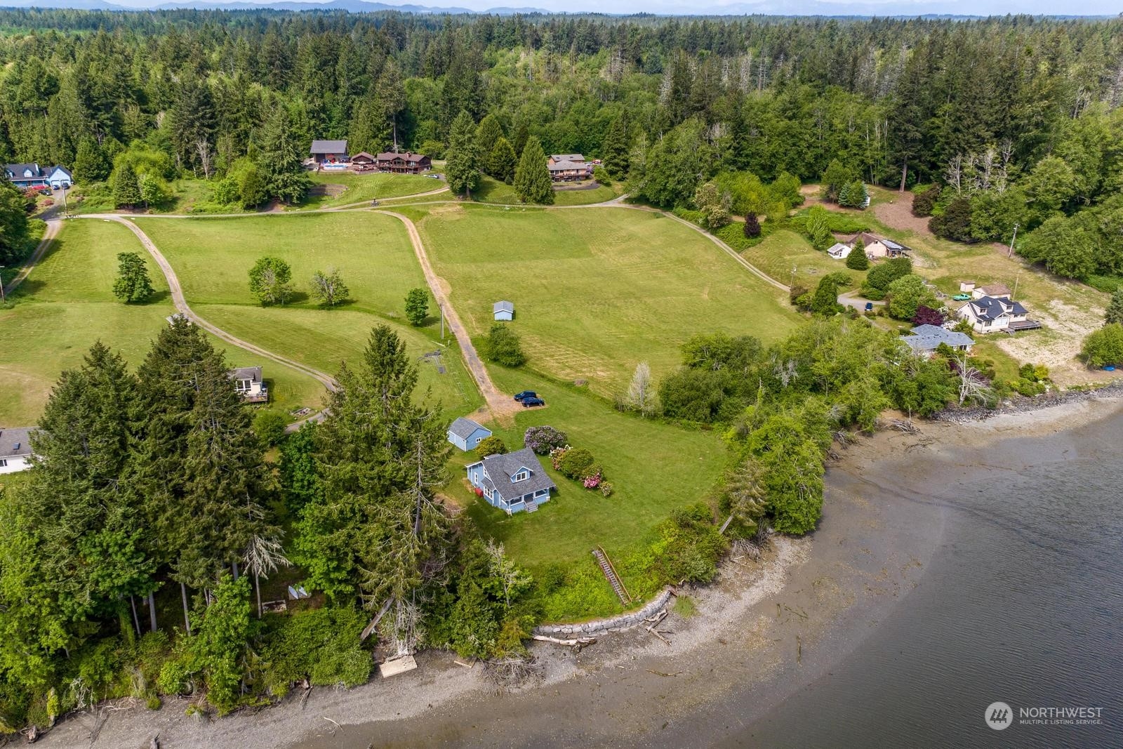 an aerial view of a house with a garden and swimming pool