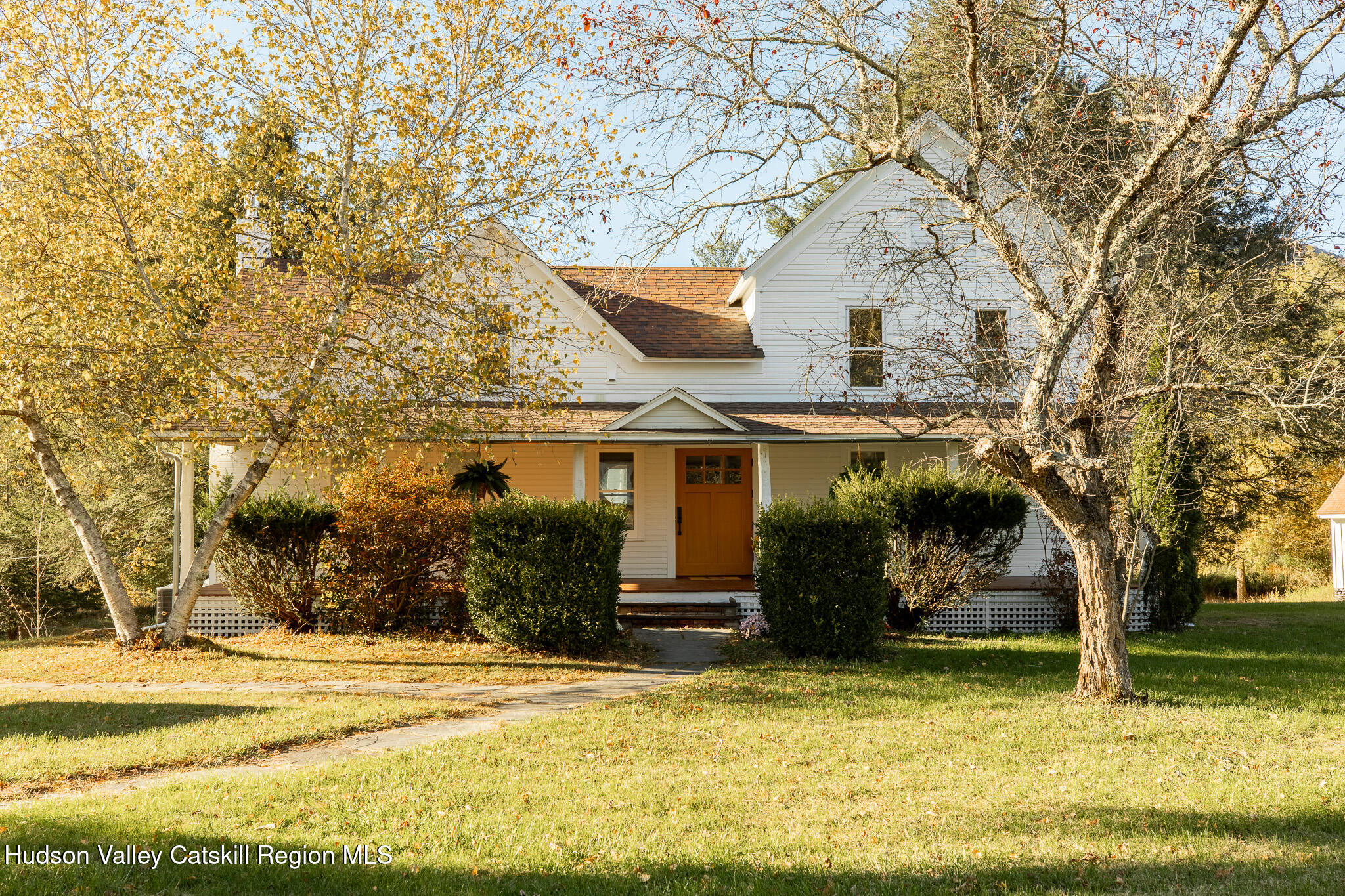 a front view of house with a garden