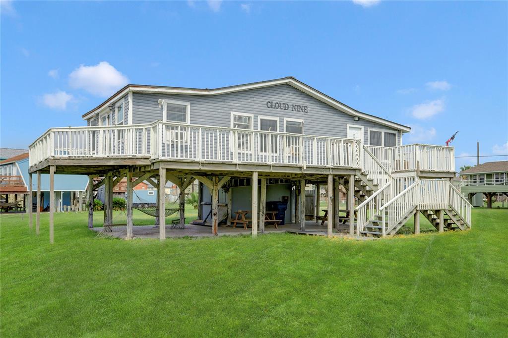 a view of a house with yard and chairs