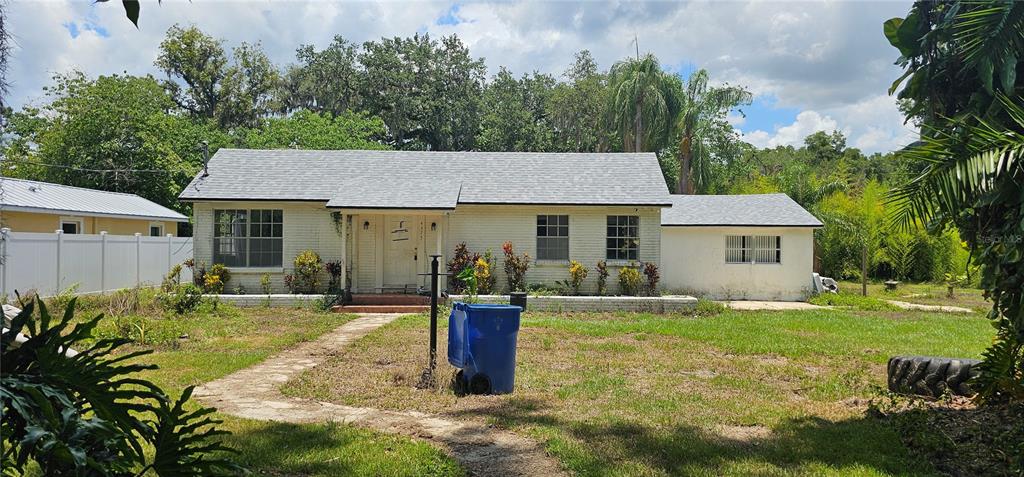 a front view of a house with yard patio and green space