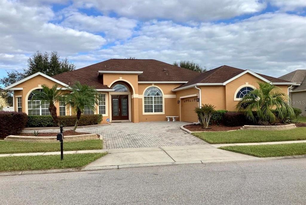 a front view of a house with a yard and garage