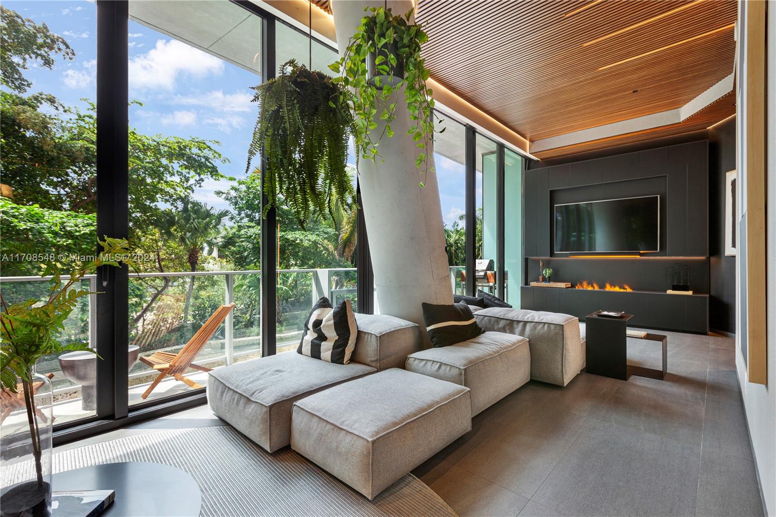 a living room with couch and a potted plant