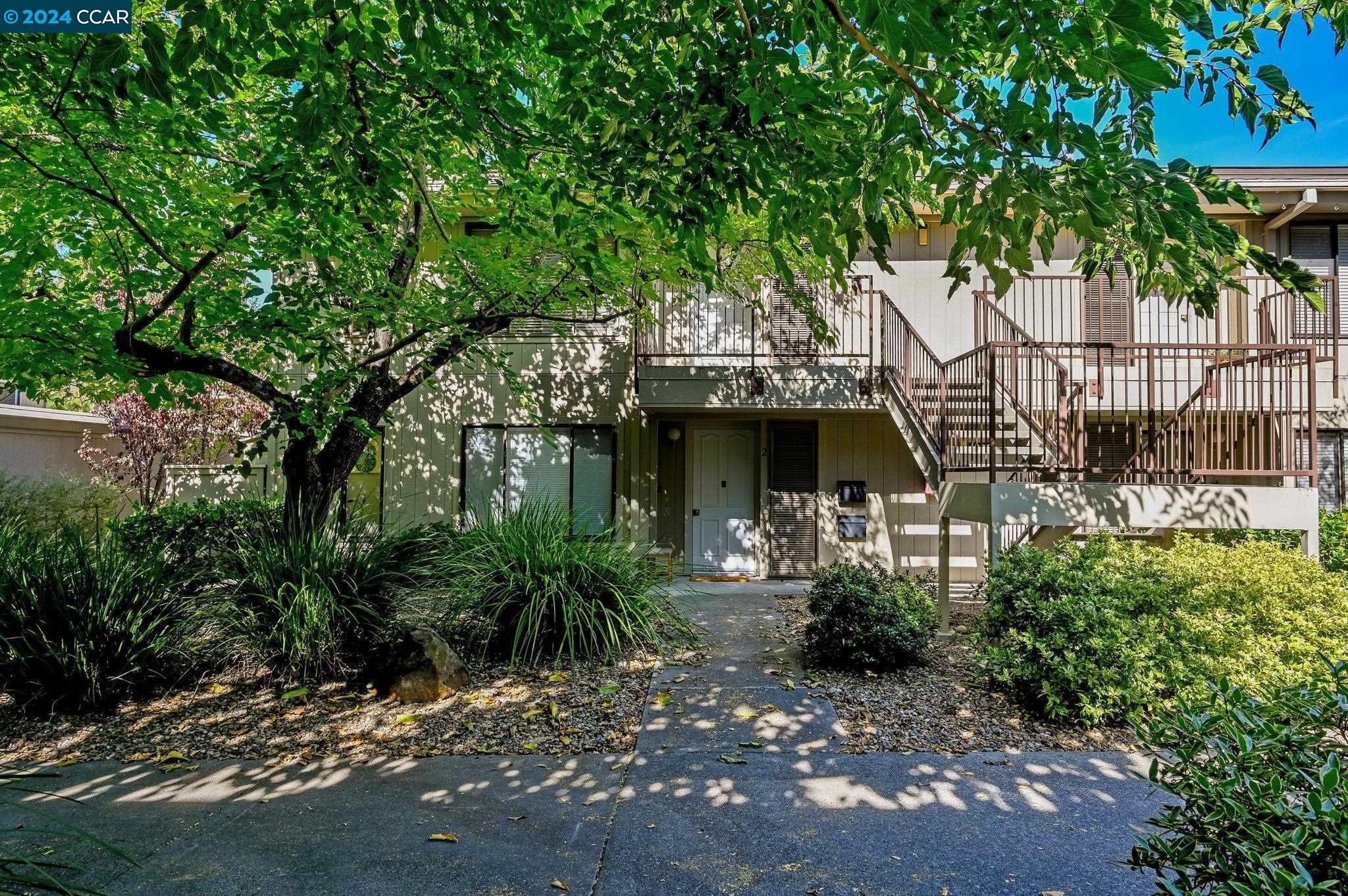 a view of a house with a tree in the background