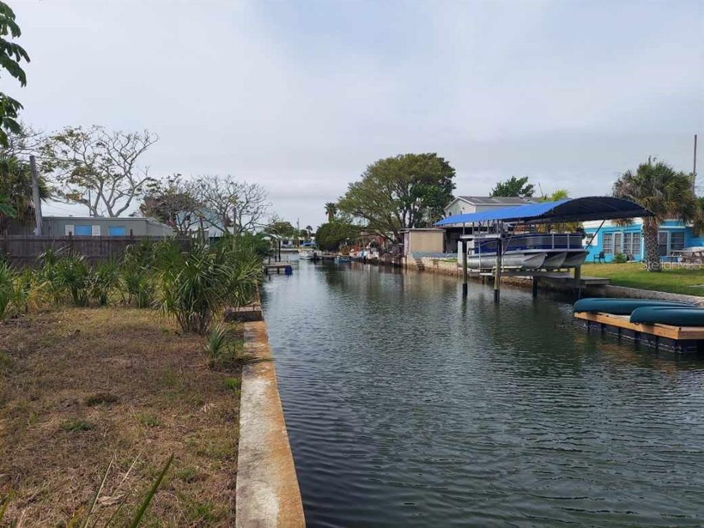 a view of swimming pool with outdoor seating and lake view