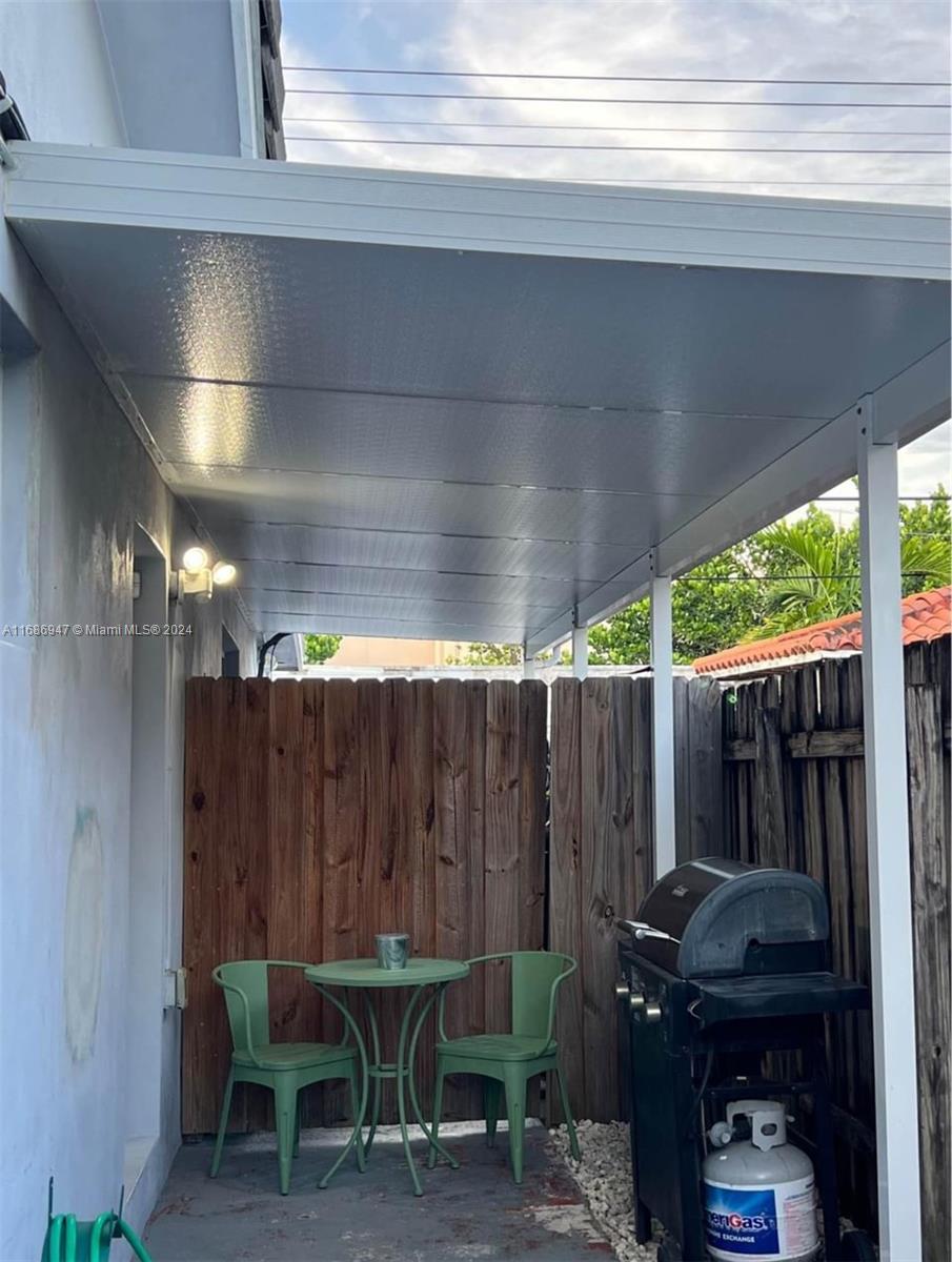 a view of a patio with table and chairs