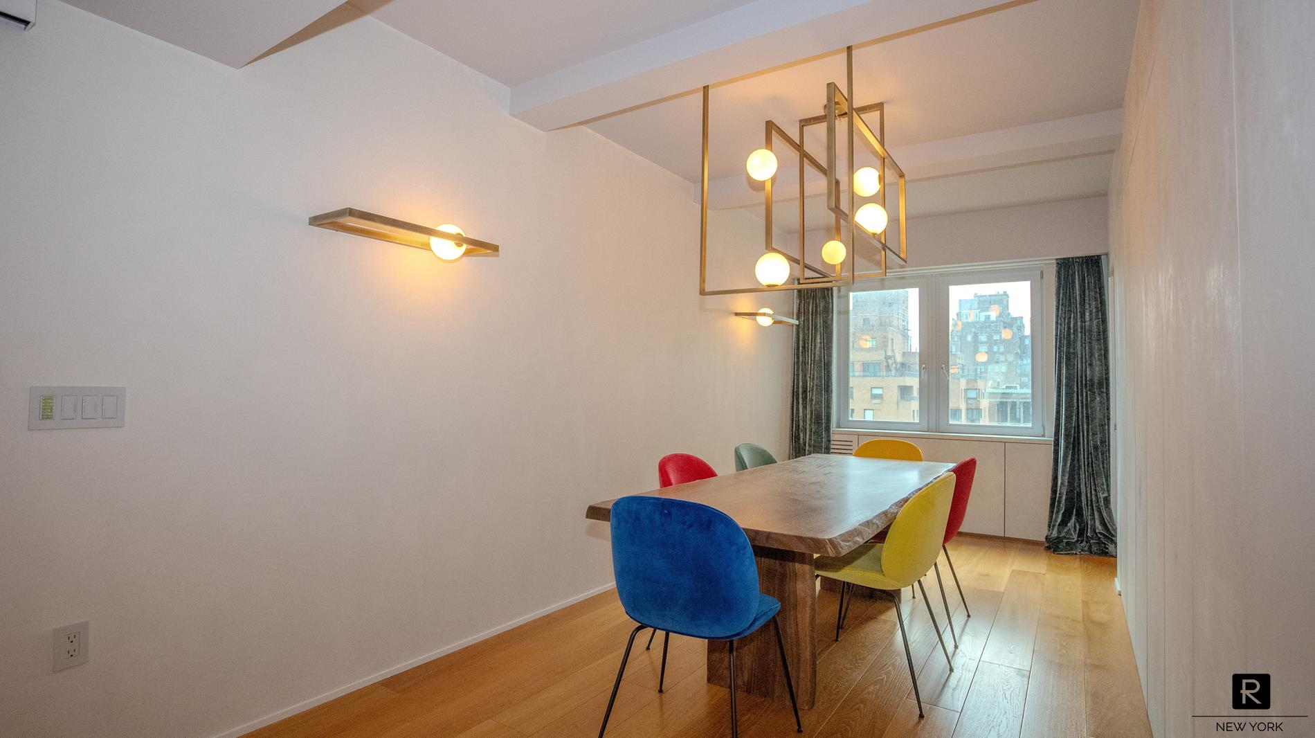 a view of a dining room with furniture and a chandelier