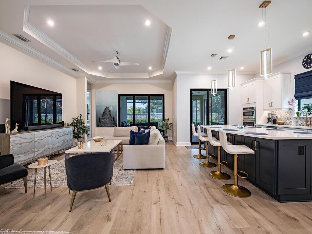 a living room with furniture a wooden floor and a fireplace