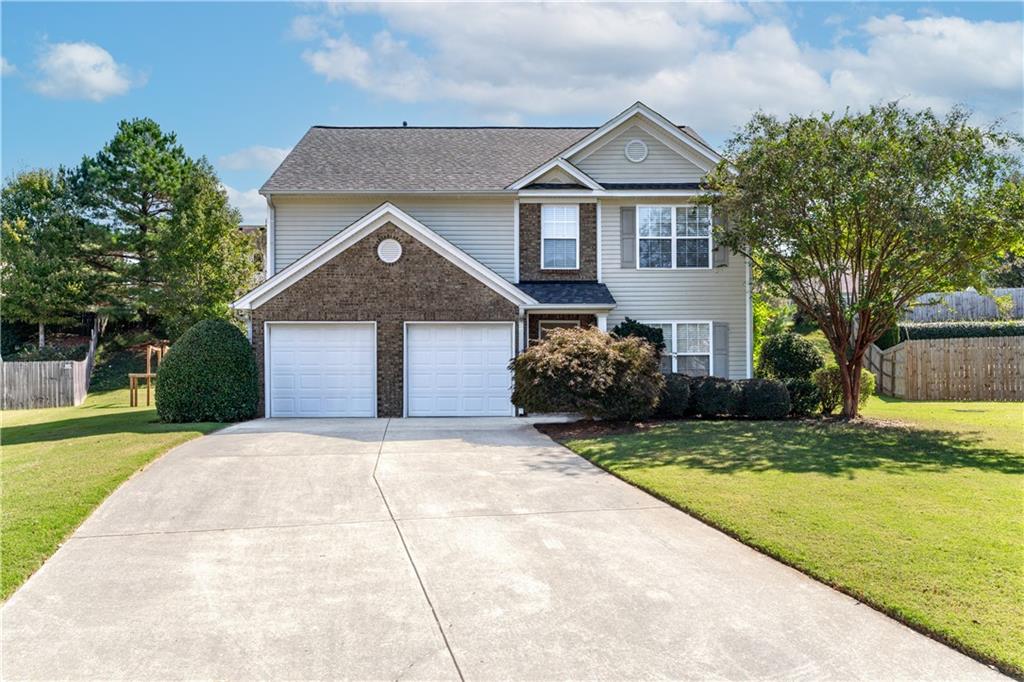 a front view of a house with a yard and garage