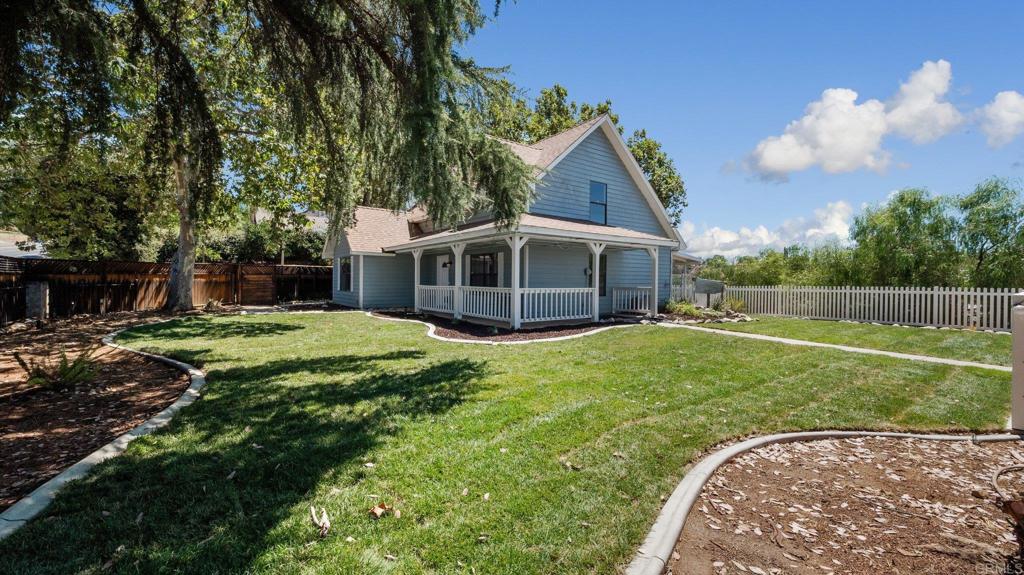 a view of a house with a backyard