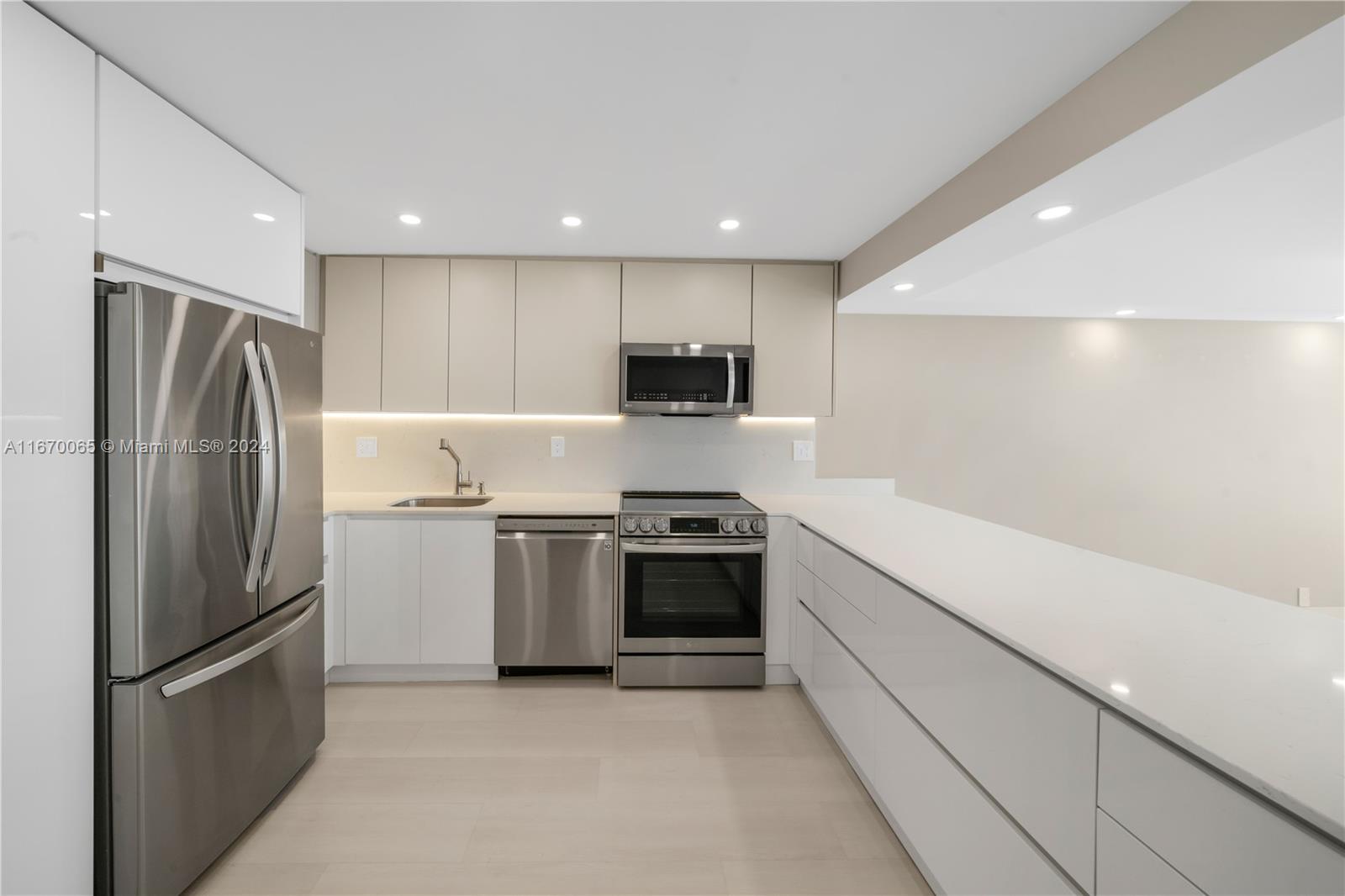 a kitchen with stainless steel appliances granite countertop a refrigerator and a stove top oven