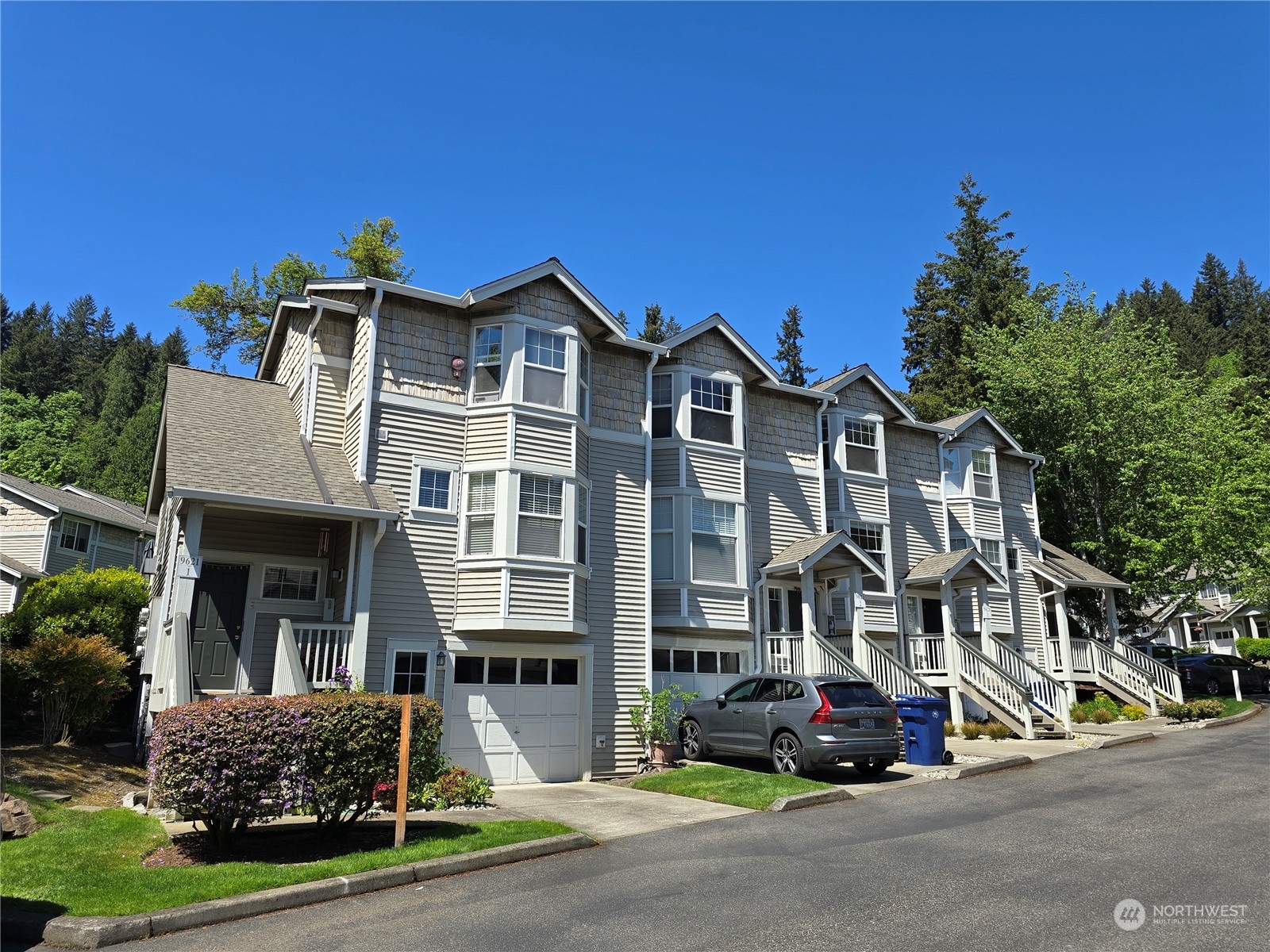 a front view of a building with cars parked