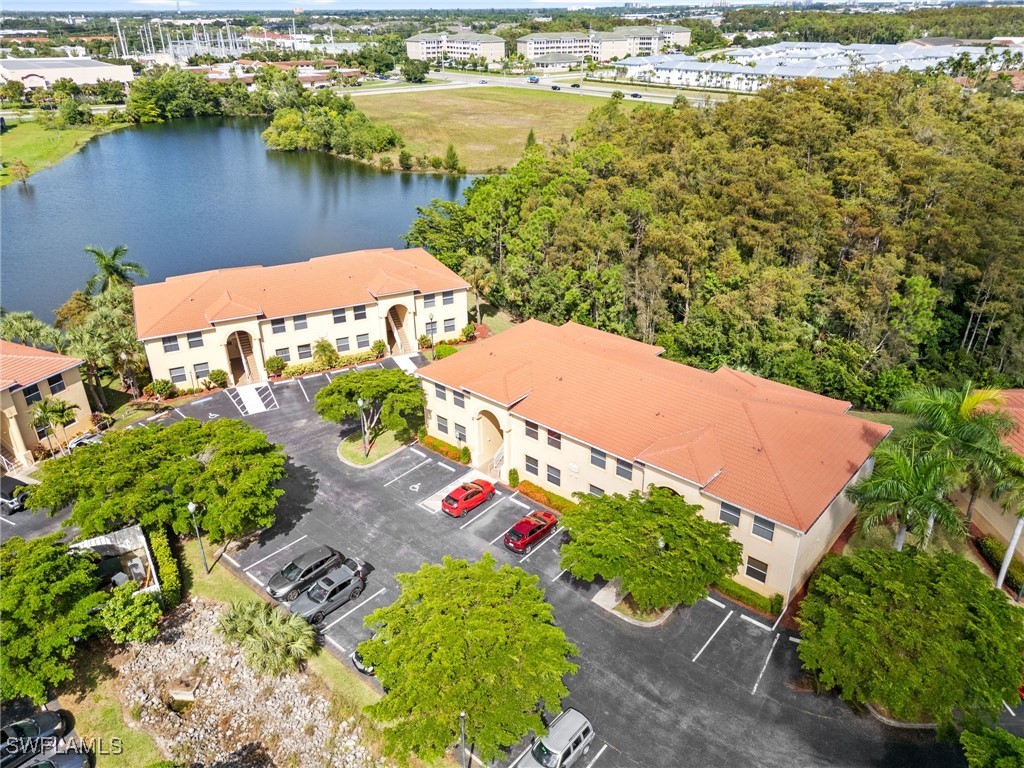 an aerial view of residential houses with outdoor space and lake view