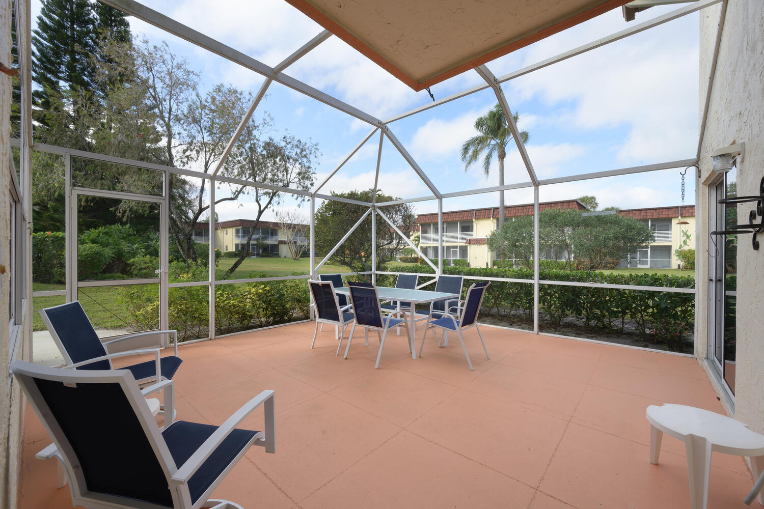 a view of a patio with a table chairs and a backyard