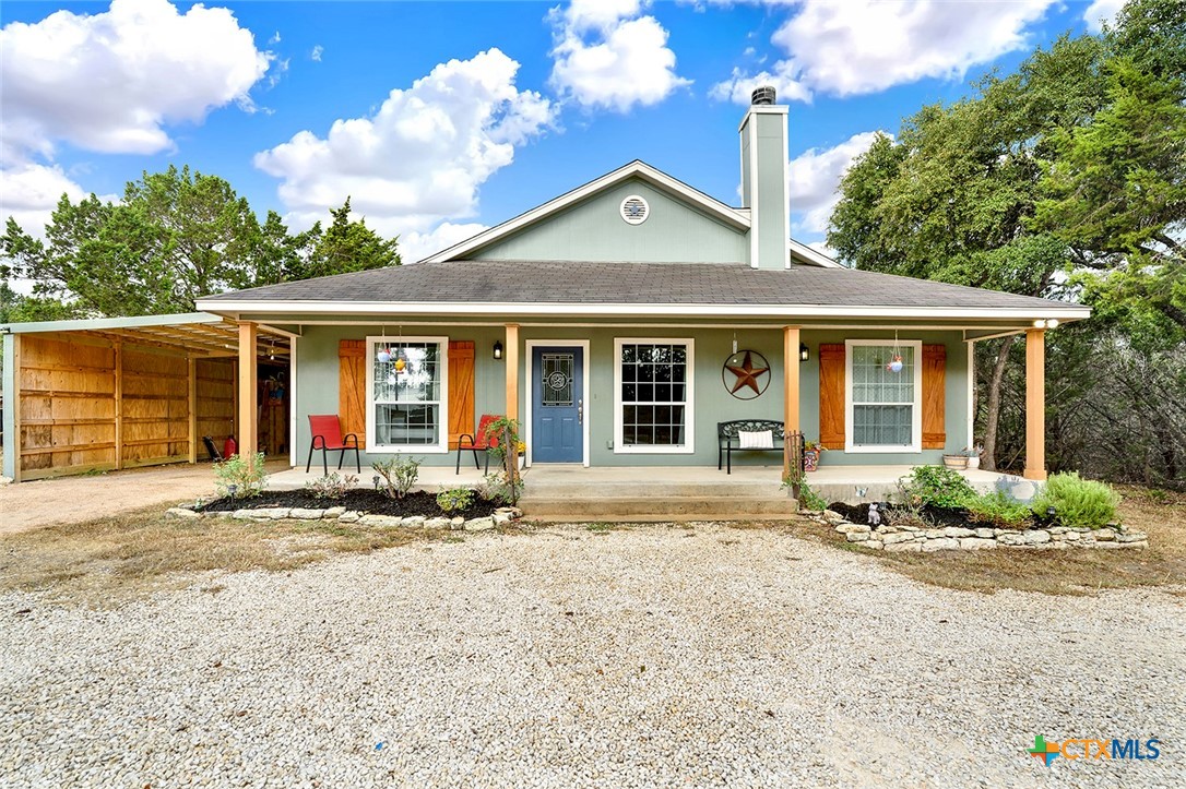 a front view of a house with a garden and yard