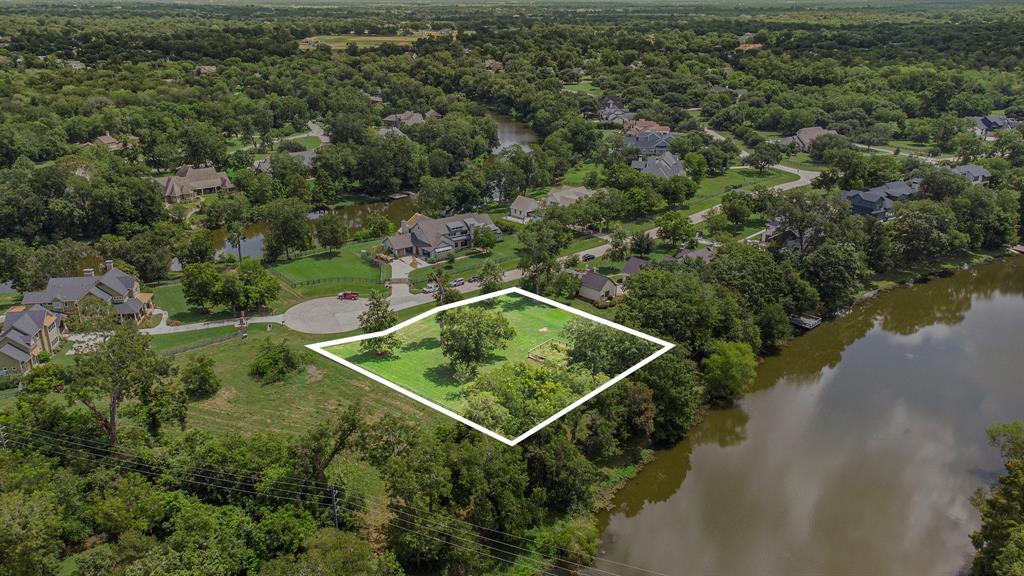 an aerial view of a house with a yard and lake view