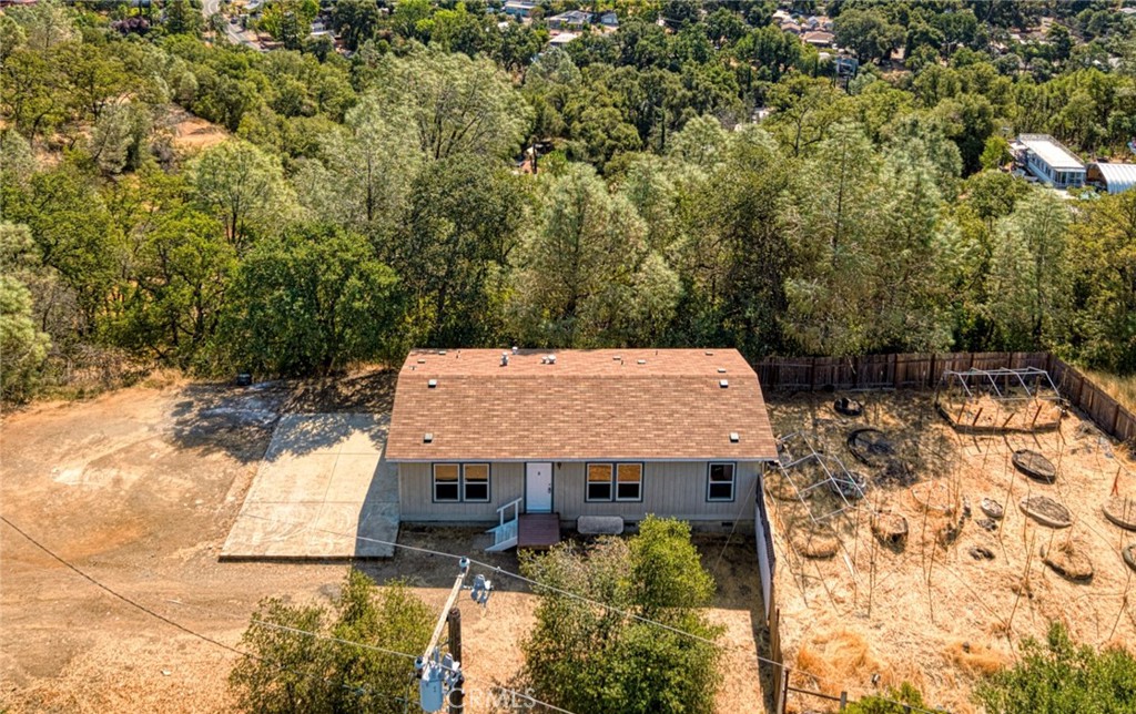 an aerial view of a house with yard