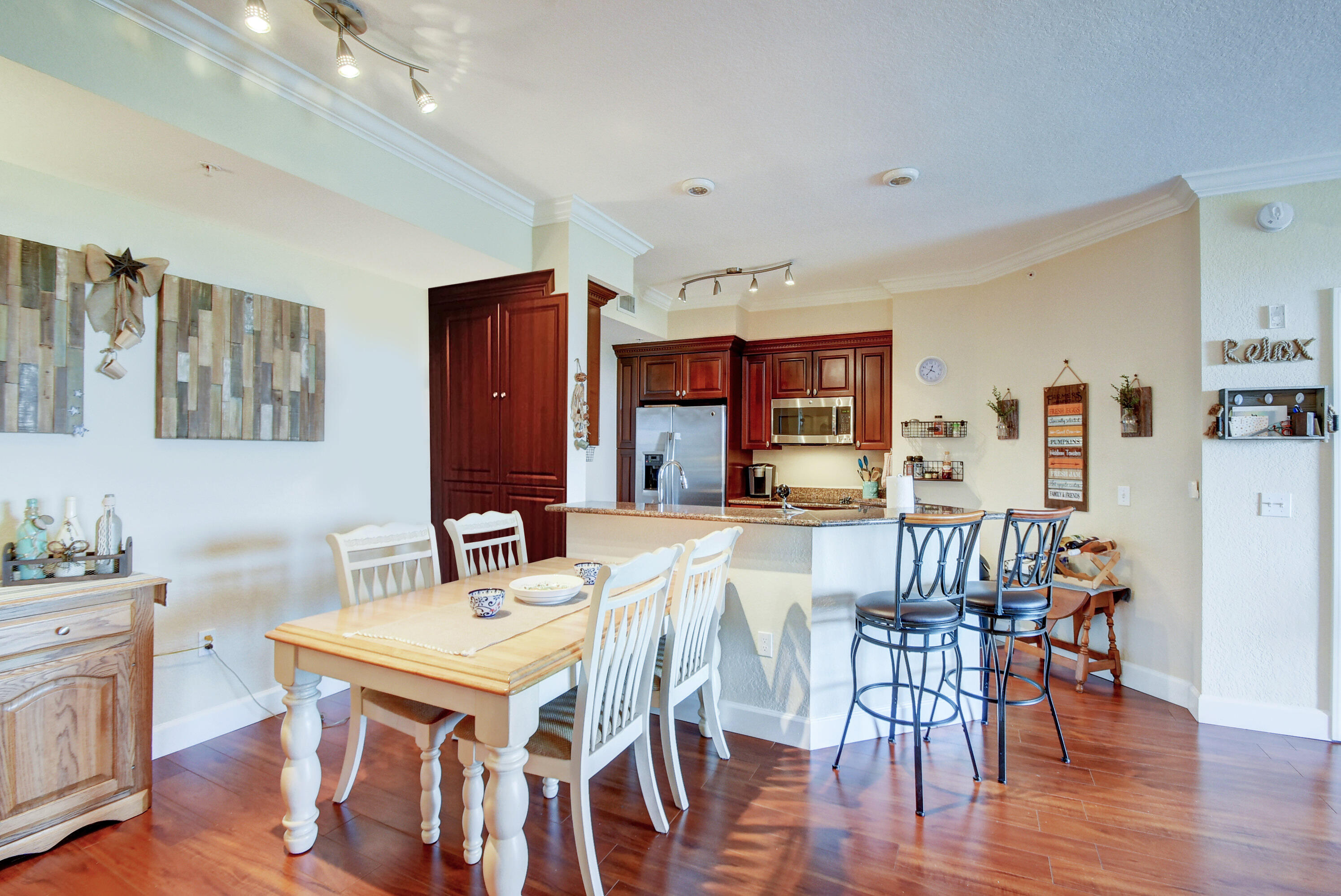 a view of a a dining room with furniture window and wooden floor