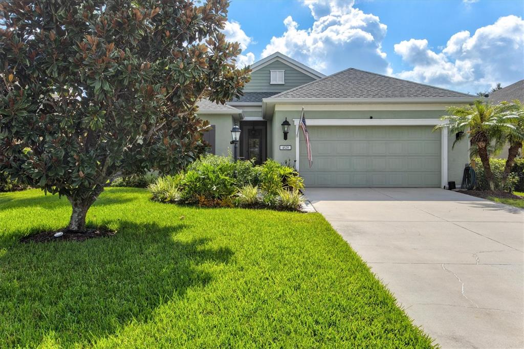 a front view of a house with a yard and garage