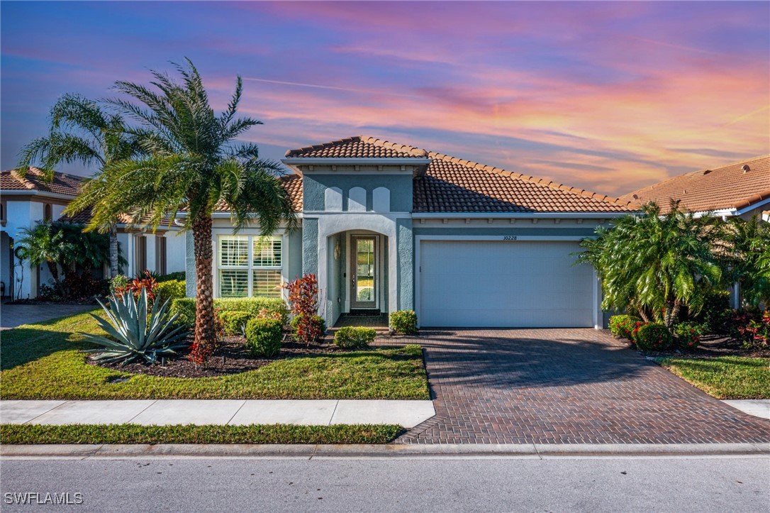 a front view of a house with a yard garage and outdoor seating