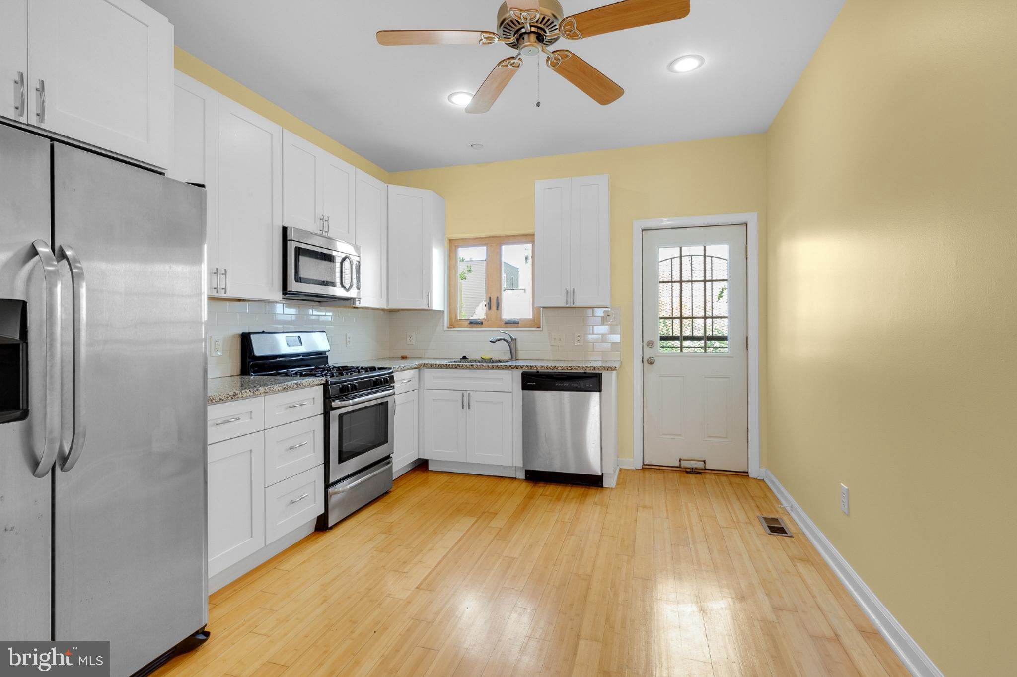 a kitchen with a white cabinets and white appliances