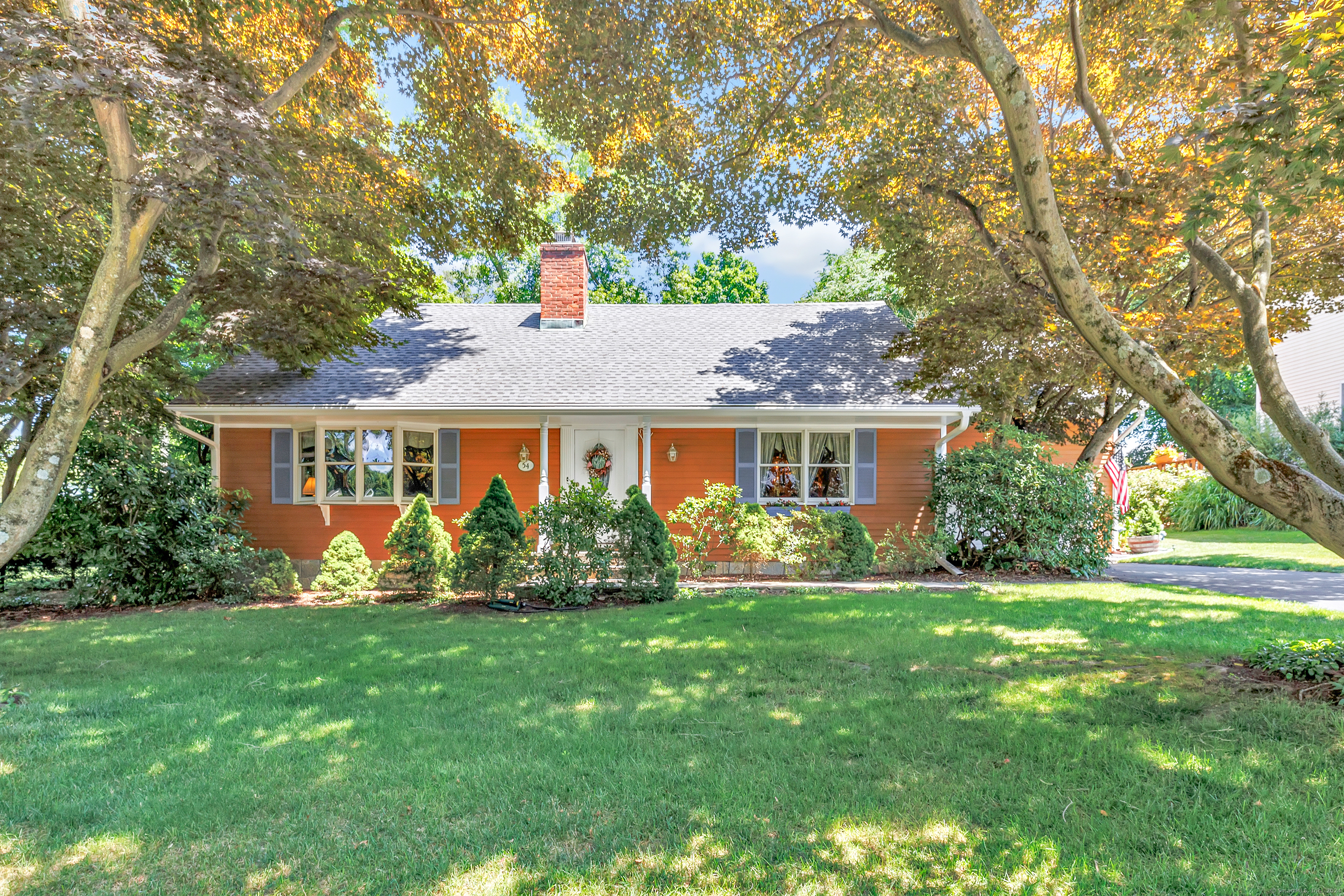 a front view of house with yard and green space