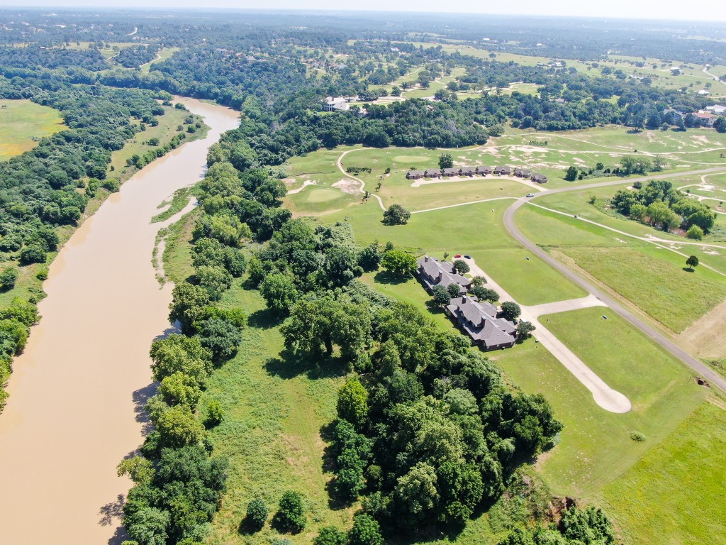 an aerial view of a houses with a lake view