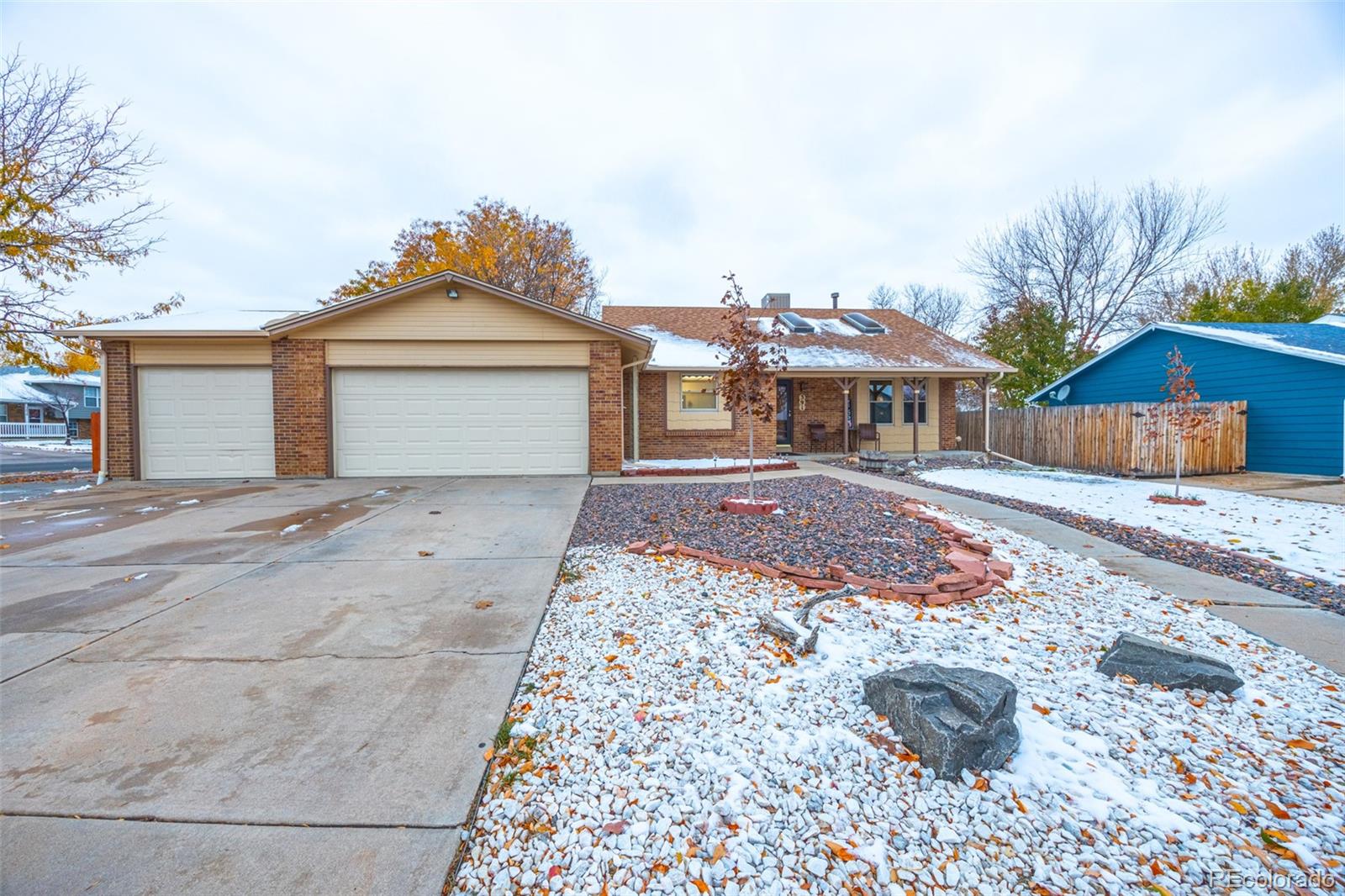 a front view of a house with a yard and a garage